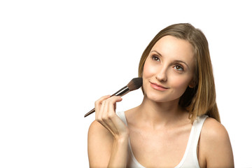 Confident woman applying makeup isolated on white.