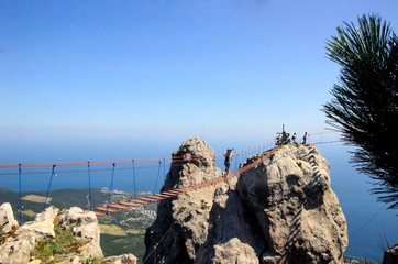 Tourists walking down Ay Petry's extreme bridge