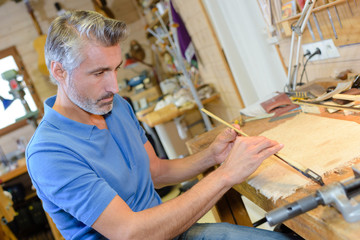 archetier finishing making violin bow