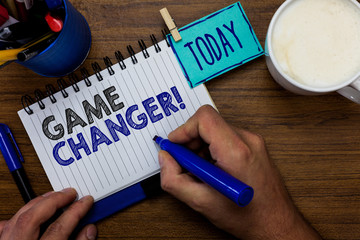 Text sign showing Game Changer. Conceptual photo Sports Data Scorekeeper Gamestreams Live Scores Team Admins Man holding marker notebook clothespin reminder wooden table cup coffee