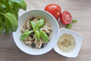 Tasty pasta with olives, dried tomatoes and herbal dressing.