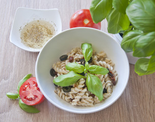 Tasty pasta with olives, dried tomatoes and herbal dressing.