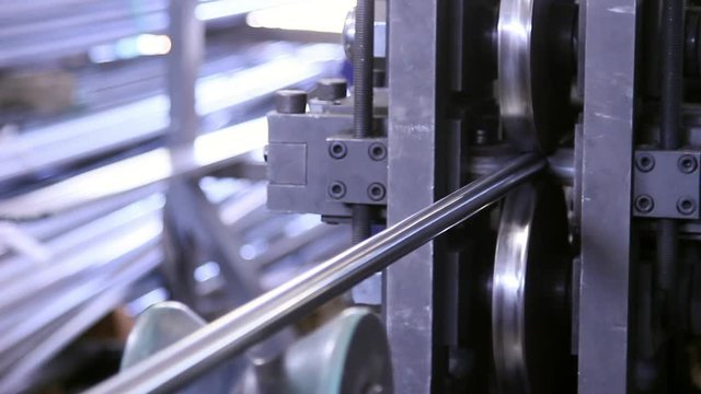 Metalworking on metal rolling machines of steel pipes in factory. Seamless technology for production of profile pipe.