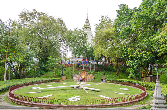 The main stupa, garden and the statue of King Sisowath  in the Wat Phnom