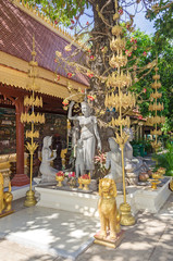 Group of statues under the cannonball tree  in a compound of the Royal palace