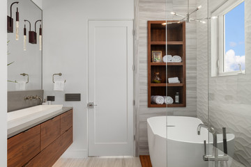 Fototapeta na wymiar modern white and wood master bathroom with bath and shower
