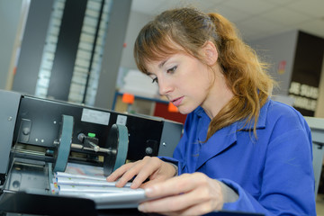 Woman setting up industrial machine