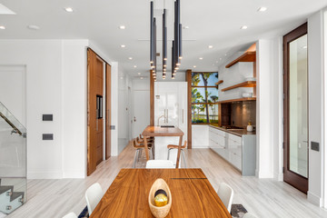 modern white open plan kitchen with wood detailing 