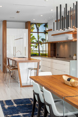 modern white kitchen and dining room with wood breakfast bar