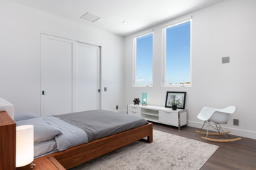 modern white secondary bedroom with a dark wooden double bed