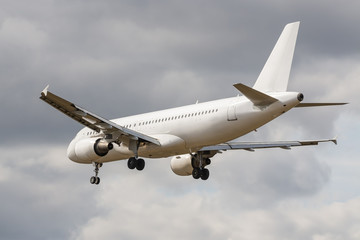 No name white passenger plane approaching to the airport