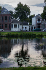 Fototapeta na wymiar Reflection of typical Dutch houses in canal water