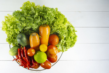 Fresh organic green vegetables bowl on white wooden background, veggies salad, diet, vegetarian, vegan food, vitamin snack,Top view, Copy space.
