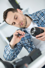 technician repairing dslr lense