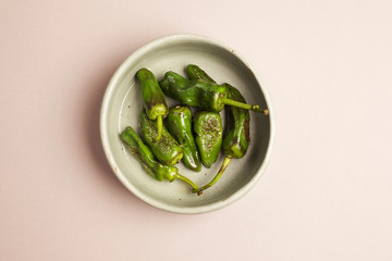 Charred green chillies in a pottery bowl