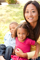 Mixed race mother and her children.