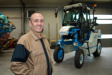 Fototapeta na wymiar man posing next to a vehicular equipment