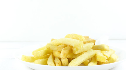 French Fries in a white dish on a table white background, Front view with copy space for your text.