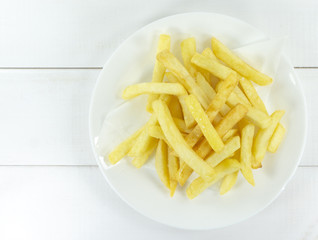 French Fries in a white dish on white background,Copy space.
