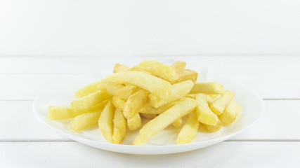 French Fries in a white dish on white background, Close up.