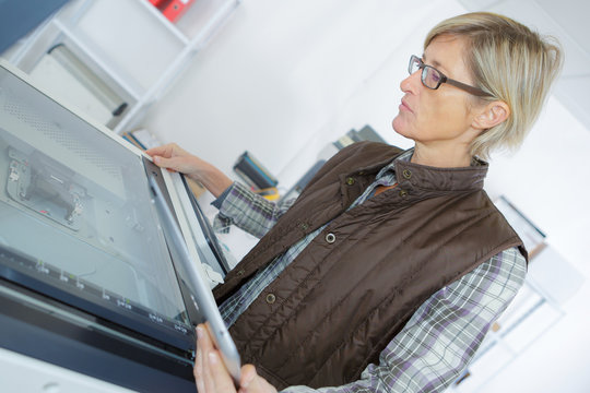 woman using printer on table