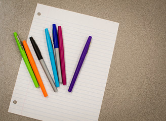 Colorful pens and paper