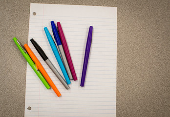 Colorful pens and paper