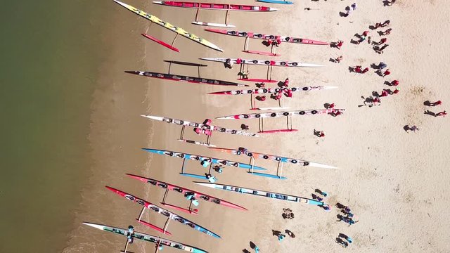 Aerial over outrigger canoes on a beach during a rowing race on the Pacific ocean near Ventura, California.