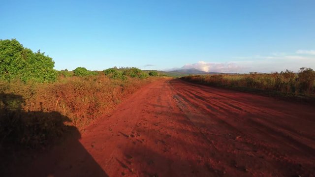 POV shot driving on a red dirt road on the island of Lanai in Hawaii.