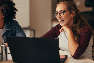 Female software engineer laughing in office