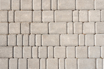 Stone tile background. Grey textured fond. Different sized pavement