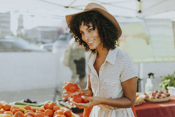 Woman buying tomatoes at a farmers market