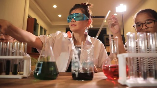 asian teacher and student in school science laboratory