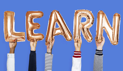 Hands holding learn balloons word