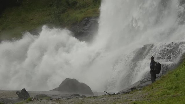 Hiker Enjoying the Scenic Waterfall Vista. Norway, Europe. Slow Motion Footage