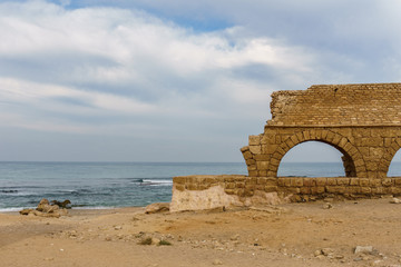 Ancient Roman ruins of aqueduct in Ceasarea Israel historical monument.