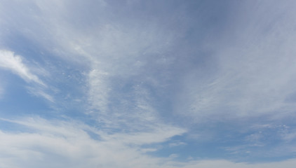 Fototapeta premium Lines of white clouds different shape on the sky.