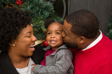 Happy African American family with their baby.