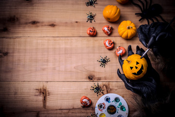 Happy Halloween. Werewolf or zombie hands painting scary pumpkin for trick or treat party. copy...