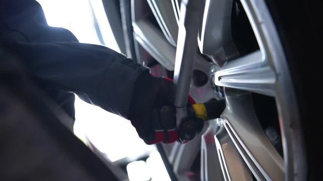 Attaching Tires After Balancing. Auto Service Footage Closeup