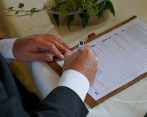 groom signing for marriage in civil registry office