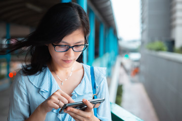Young woman use smartphone on Footbridge