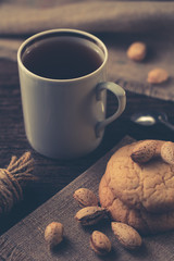 A cup of black tea with cookies.