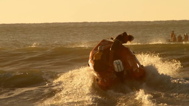Beach surf lifeguard rescue boat over waves