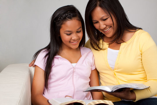 Asian Mother And Daughter Reading And Studying.