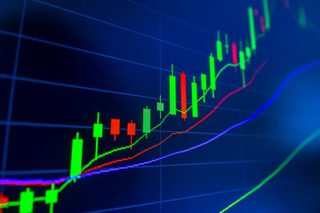 Stock market graph analysis. Stock market data on LED display on laptop screen for finance and economic. Business graph background.