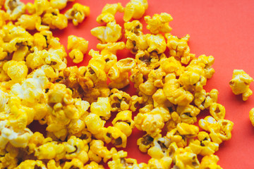 Popcorn on red background close up.