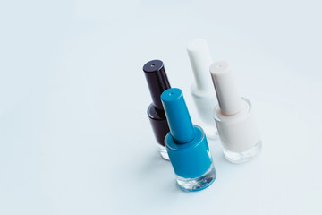 Nail polish of different colors on a light gray background