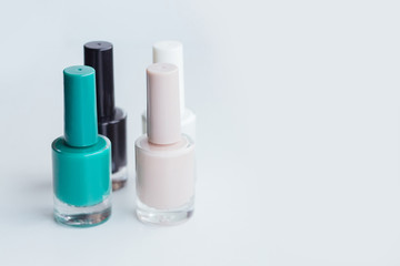 Nail polish of different colors on a light gray background