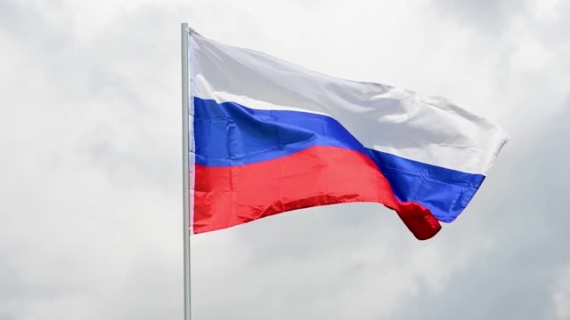 The Russian flag waves in the wind in slow motion.